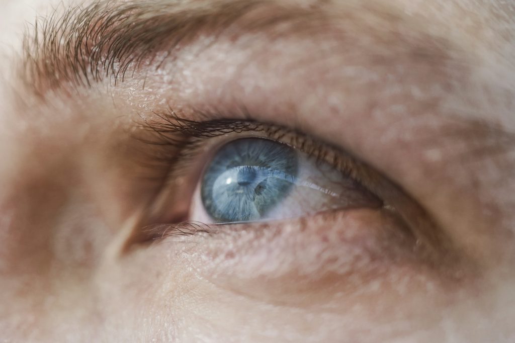 close up macro photo of a blue human eye showing details related to dry eye in Oakville
